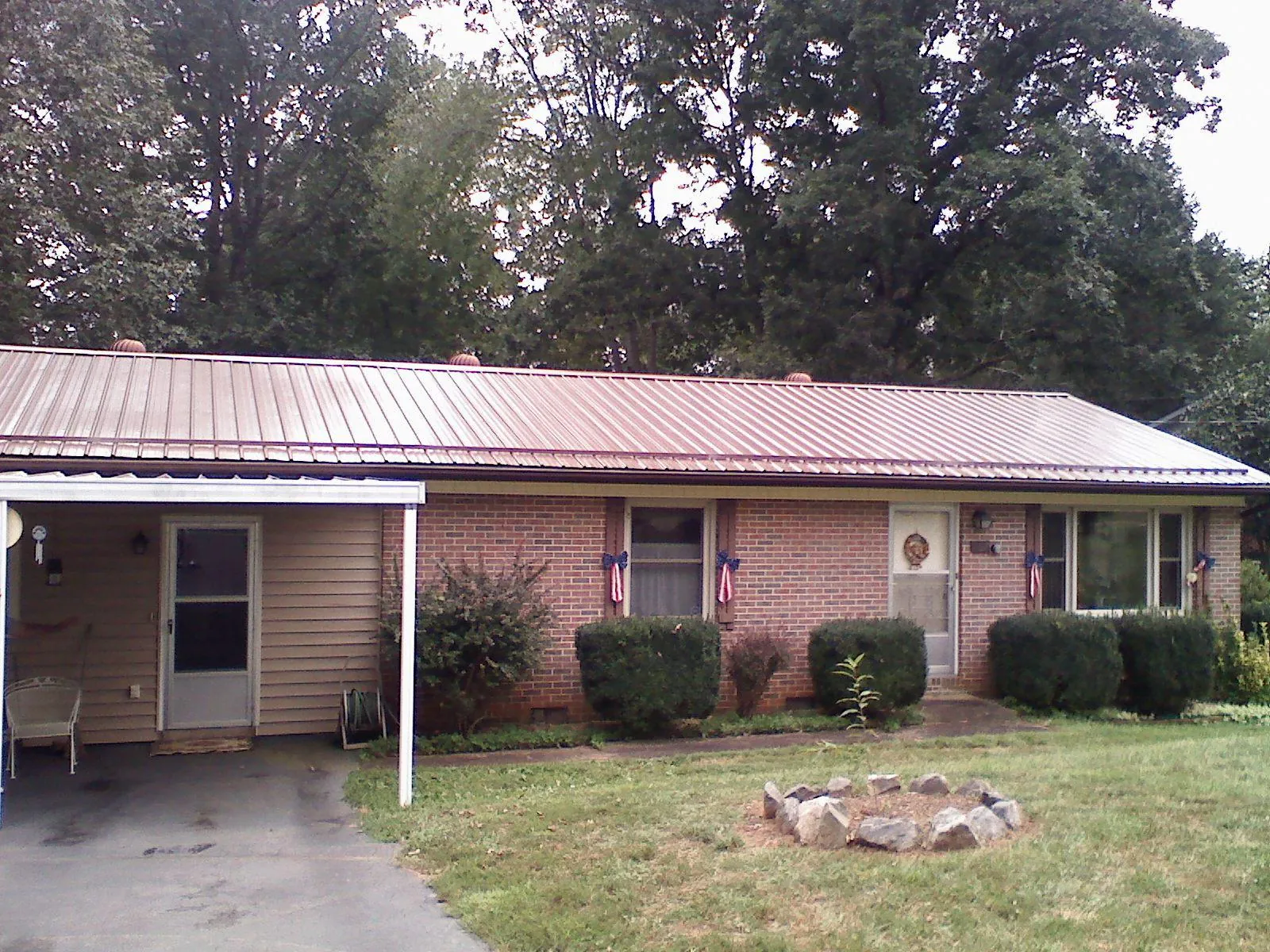 Bronze metal roof and carport on a brick ranch home — Roof Repair work by our crew in Carbondale